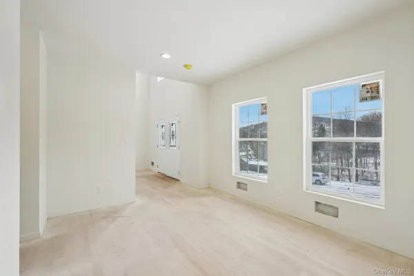 a view of staircase with lots of frames on wall and a window