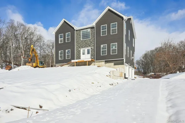 a view of house with snow on the road