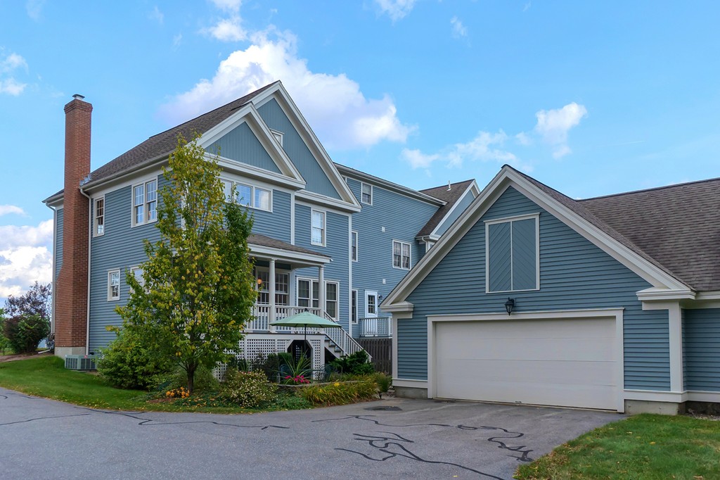 35 Lancaster County Road, Unit 4C Harvard, MA 01451 - Photo 2 of 2 a front view of a house with garden