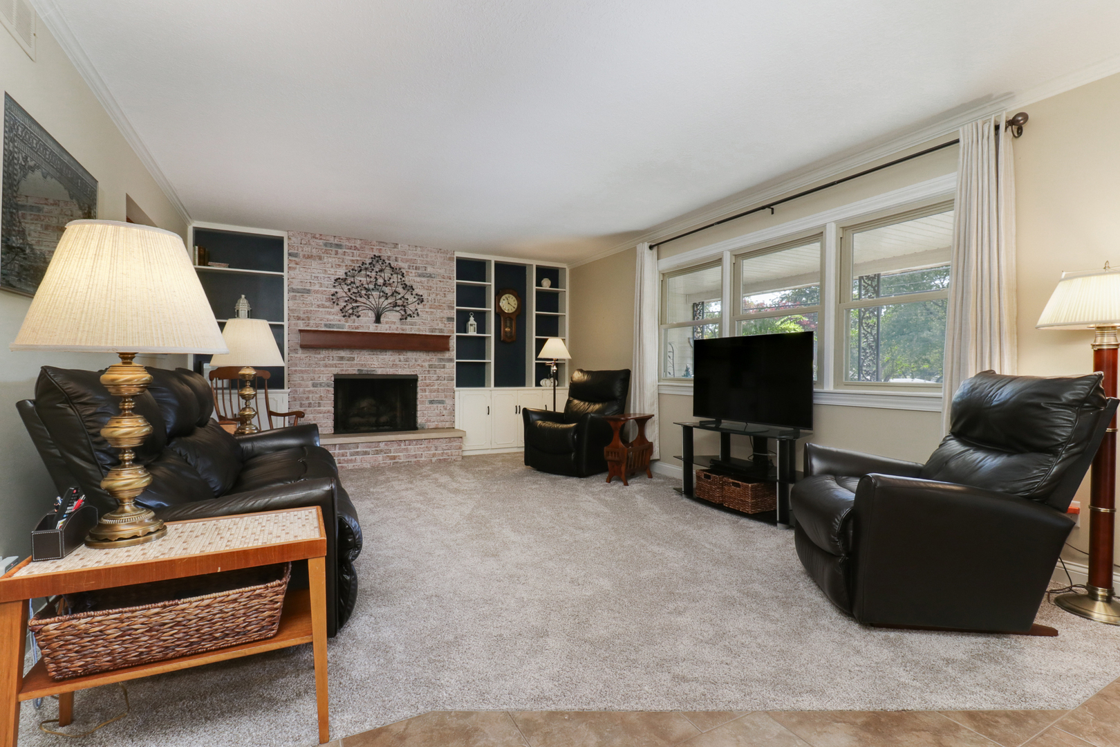 502 Jersey Avenue Normal, IL 61761 - Photo 13 of 46 a living room with furniture a flat screen tv and a fireplace