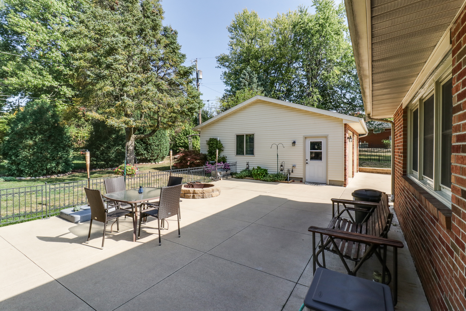 502 Jersey Avenue Normal, IL 61761 - Photo 37 of 46 a view of a patio with table and chairs and floor to ceiling window