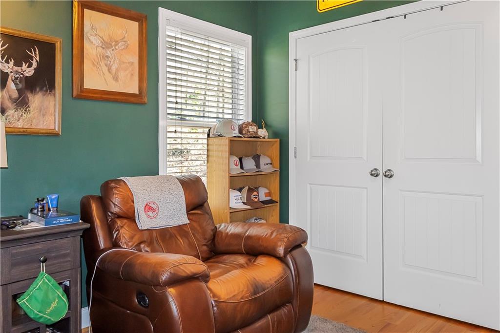 235 Brooks Road Pendergrass, GA 30567 - Photo 20 of 33 a blue couch sitting in a room next to a window