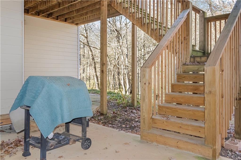 235 Brooks Road Pendergrass, GA 30567 - Photo 31 of 33 a view of staircase with wooden floor and chair