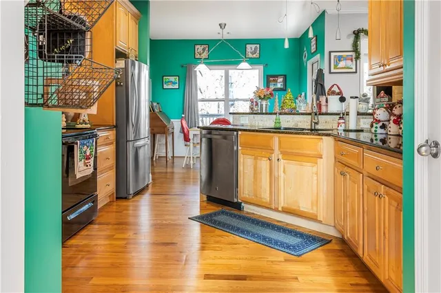 a kitchen with stainless steel appliances granite countertop a refrigerator and microwave