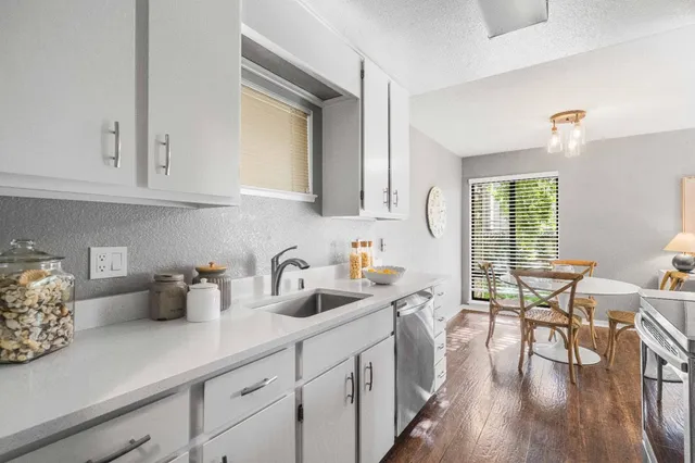 a kitchen with stainless steel appliances granite countertop a sink stove and cabinets