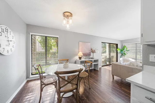 a living room with furniture a fireplace and a potted plant
