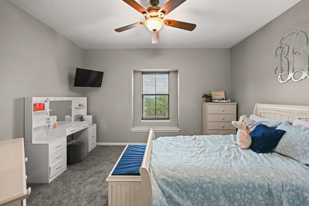 5528 Wild Foxglove Road Spicewood, TX 78669 - Photo 28 of 38 a bedroom with a bed and a window