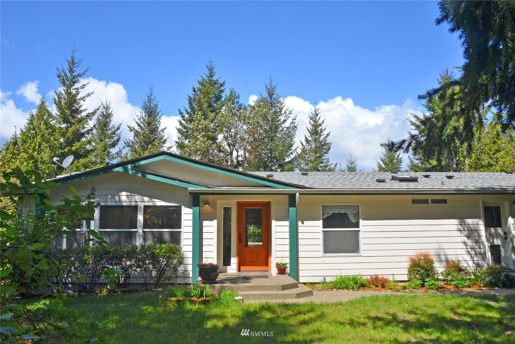 4704 Whiteman Road Southwest Longbranch, WA 98351 - Photo 1 of 40 a front view of a house with garden