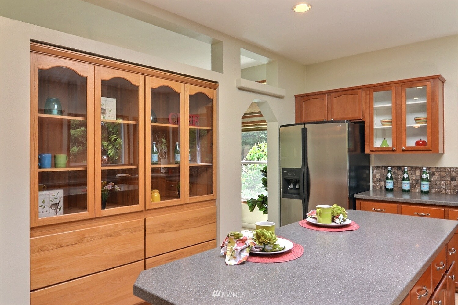 4704 Whiteman Road Southwest Longbranch, WA 98351 - Photo 11 of 40 a view of a dining room with furniture a chandelier and window