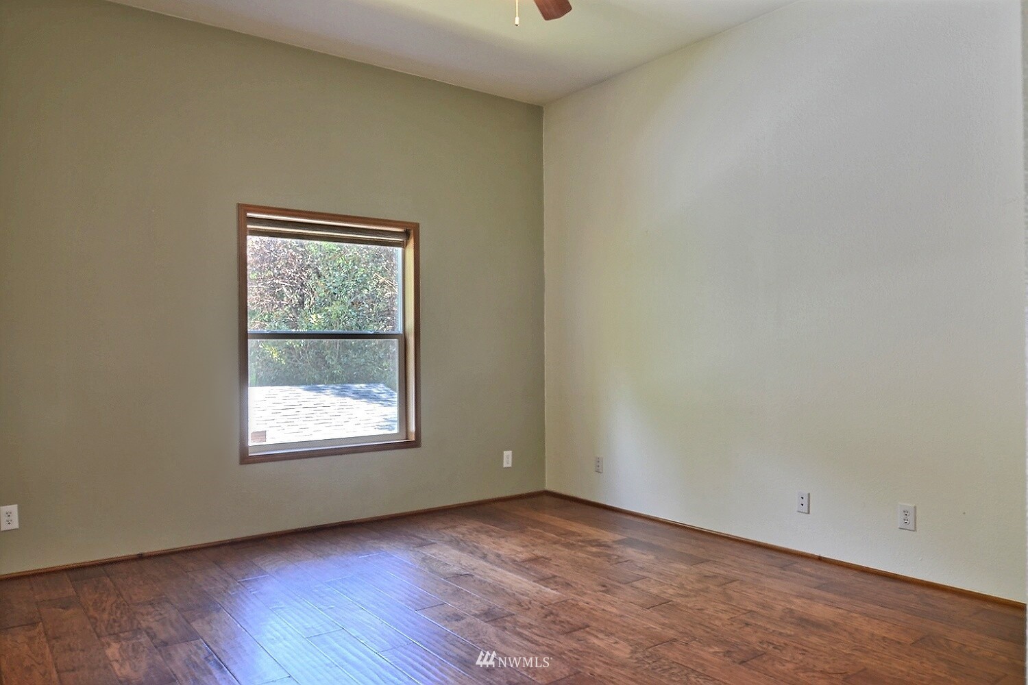 4704 Whiteman Road Southwest Longbranch, WA 98351 - Photo 13 of 40 an empty room with wooden floor and windows