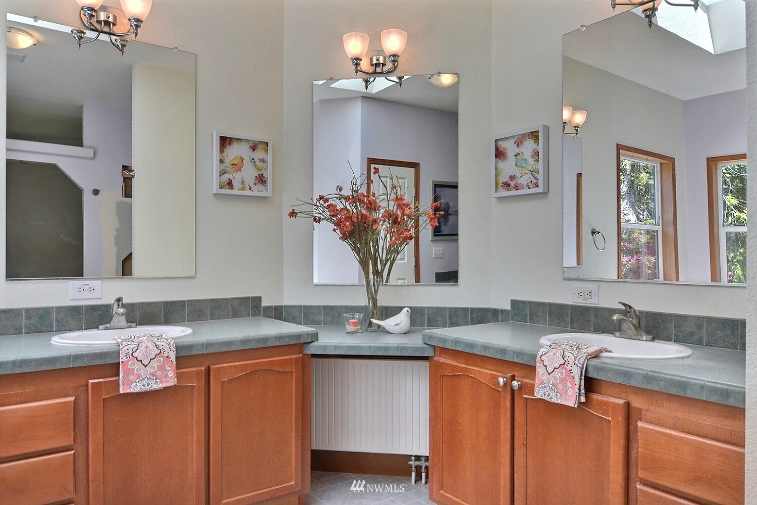 4704 Whiteman Road Southwest Longbranch, WA 98351 - Photo 15 of 40 a bathroom with cabinets a sink and a mirror