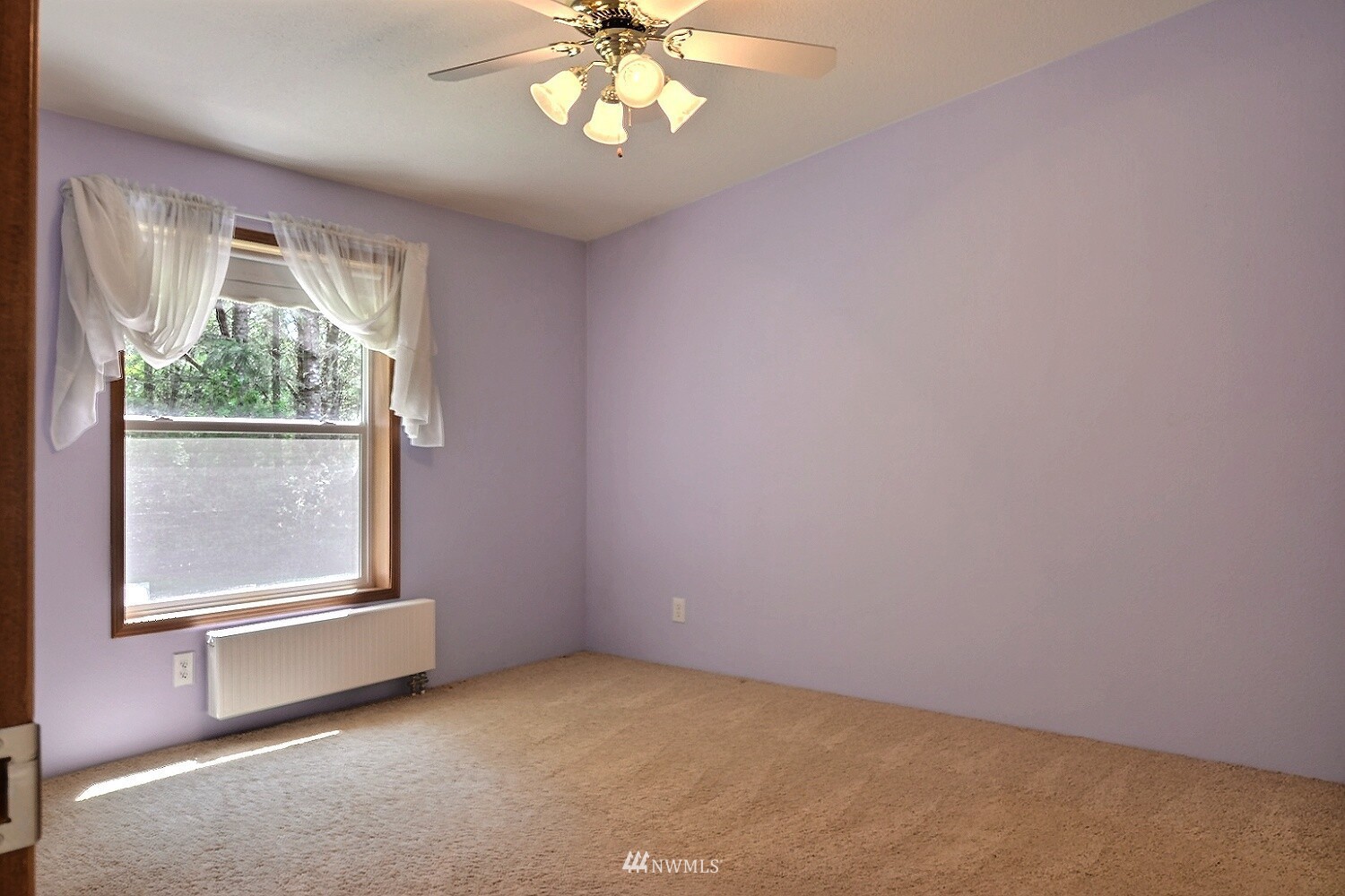 4704 Whiteman Road Southwest Longbranch, WA 98351 - Photo 17 of 40 an empty room with windows and chandelier fan