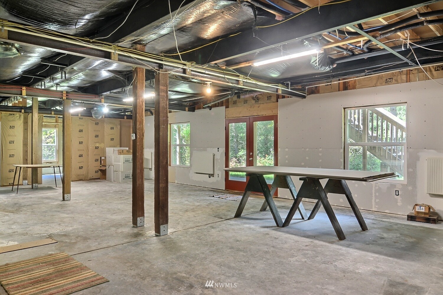4704 Whiteman Road Southwest Longbranch, WA 98351 - Photo 24 of 40 a view of an empty room with wooden floor and windows