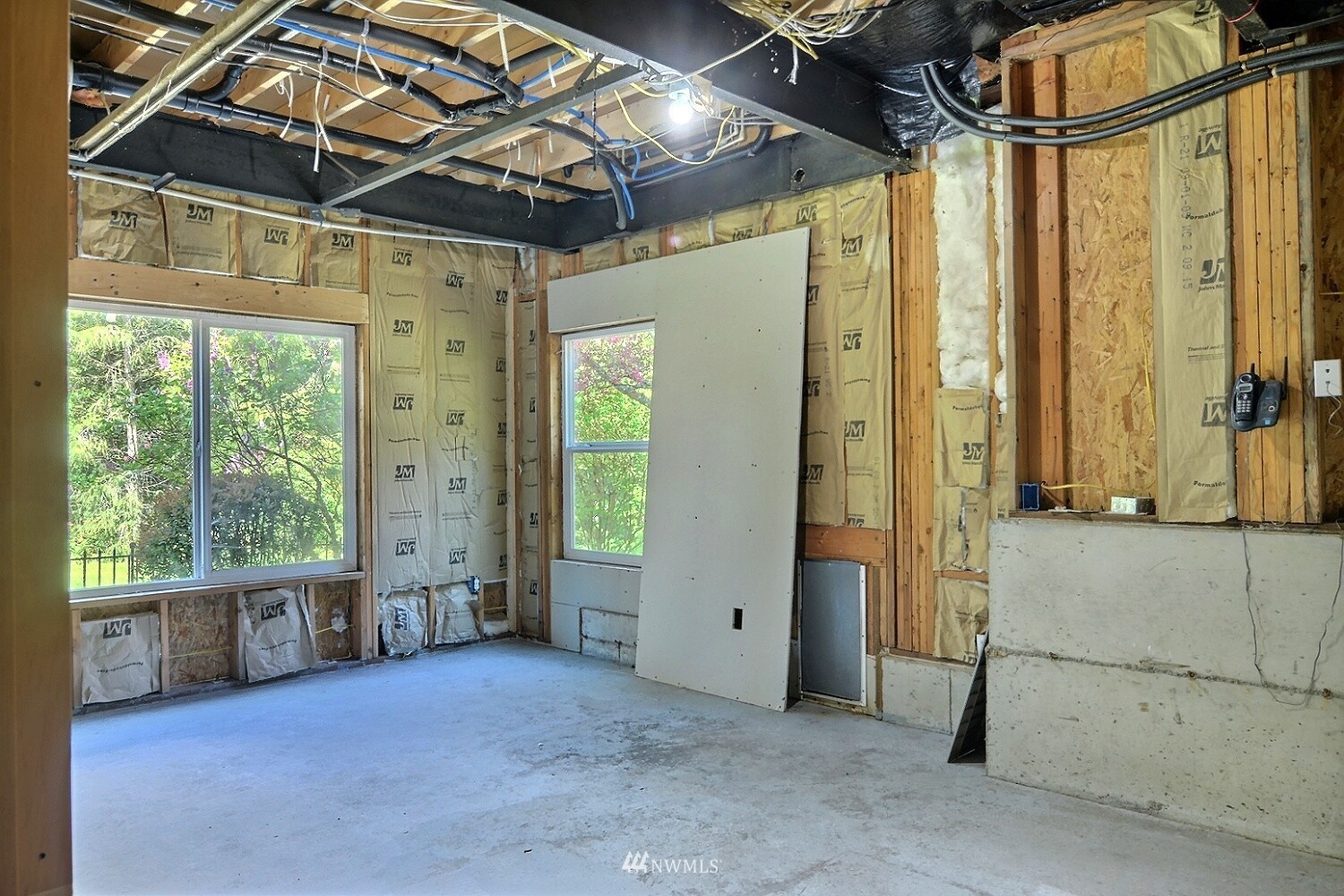 4704 Whiteman Road Southwest Longbranch, WA 98351 - Photo 25 of 40 a view of empty room with wooden floor and windows