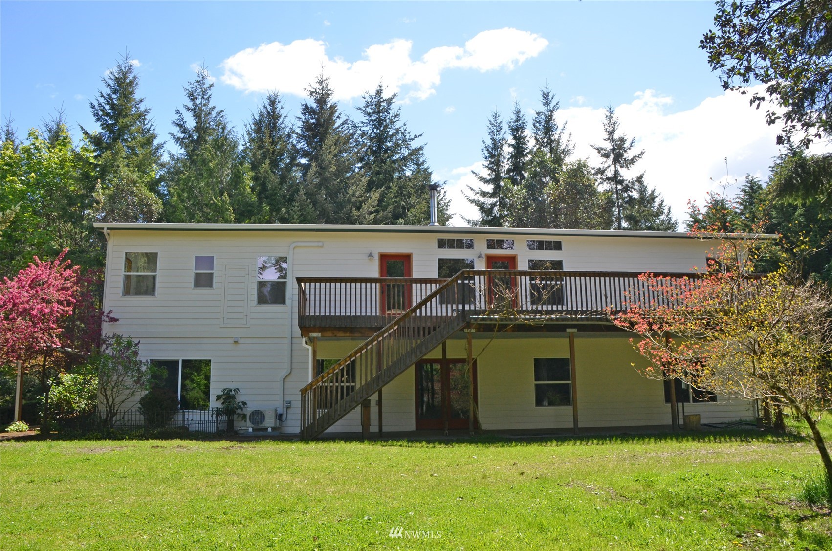 4704 Whiteman Road Southwest Longbranch, WA 98351 - Photo 29 of 40 a view of a house with a yard and a garden