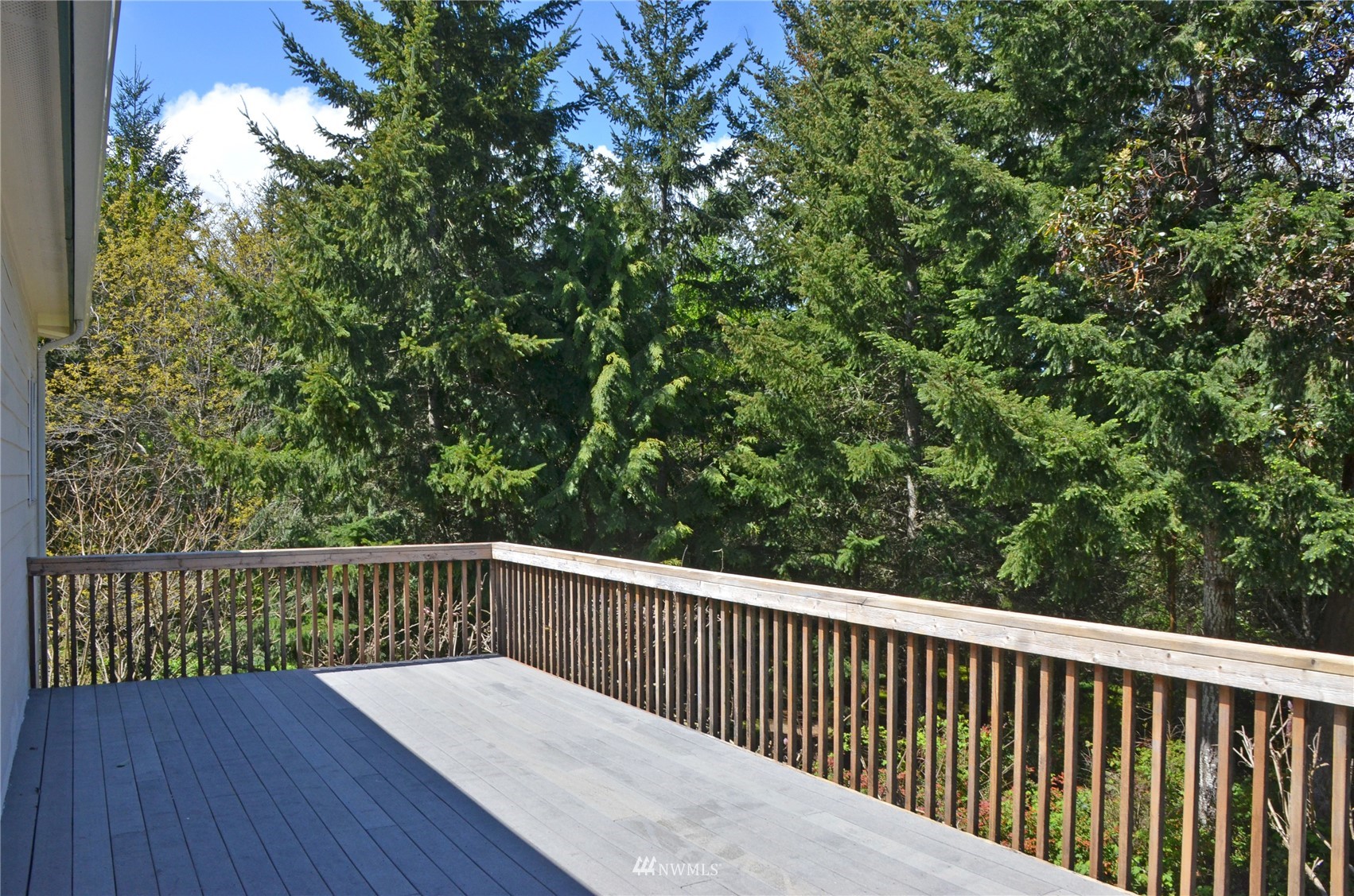 4704 Whiteman Road Southwest Longbranch, WA 98351 - Photo 30 of 40 a balcony with wooden floor and fence