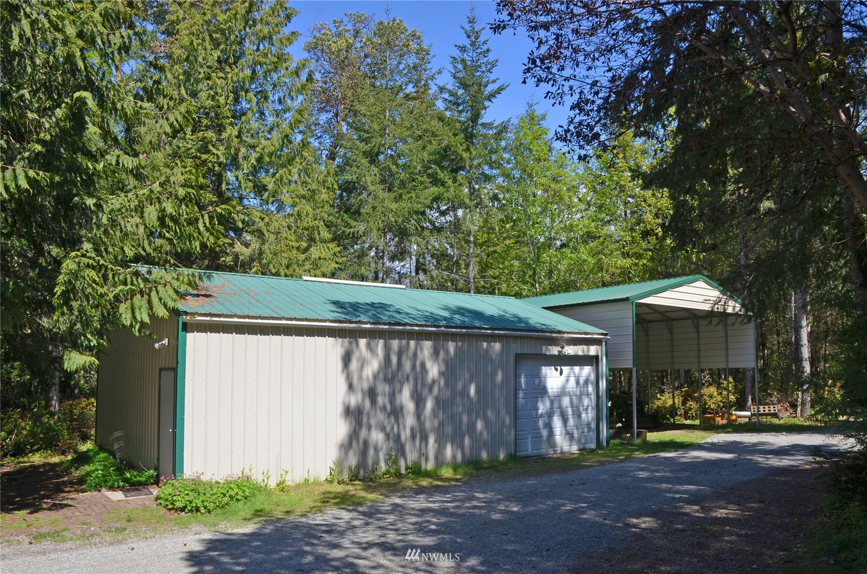 4704 Whiteman Road Southwest Longbranch, WA 98351 - Photo 31 of 40 a front view of a house with garden