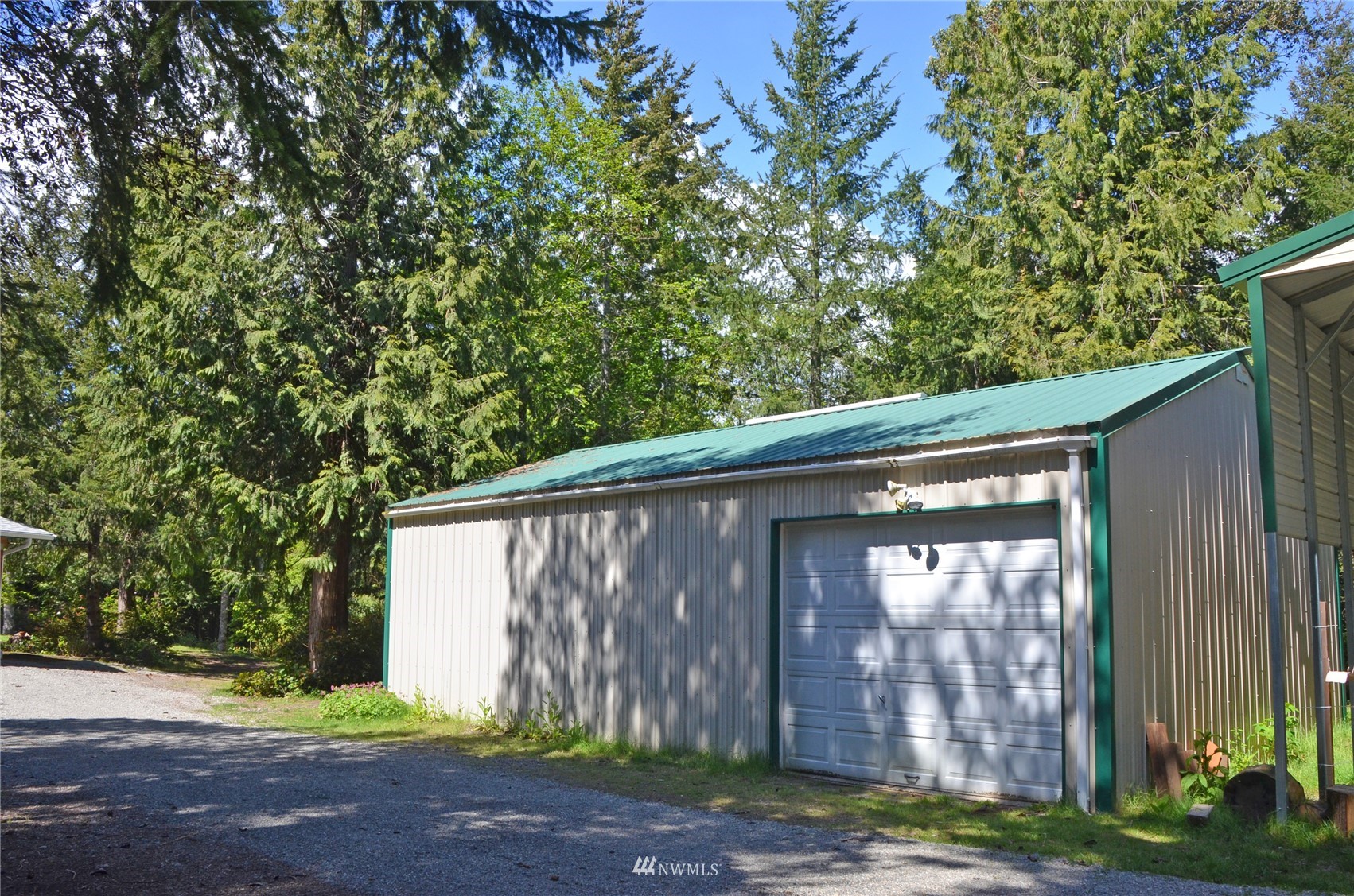 4704 Whiteman Road Southwest Longbranch, WA 98351 - Photo 32 of 40 a backyard of a house with seating space