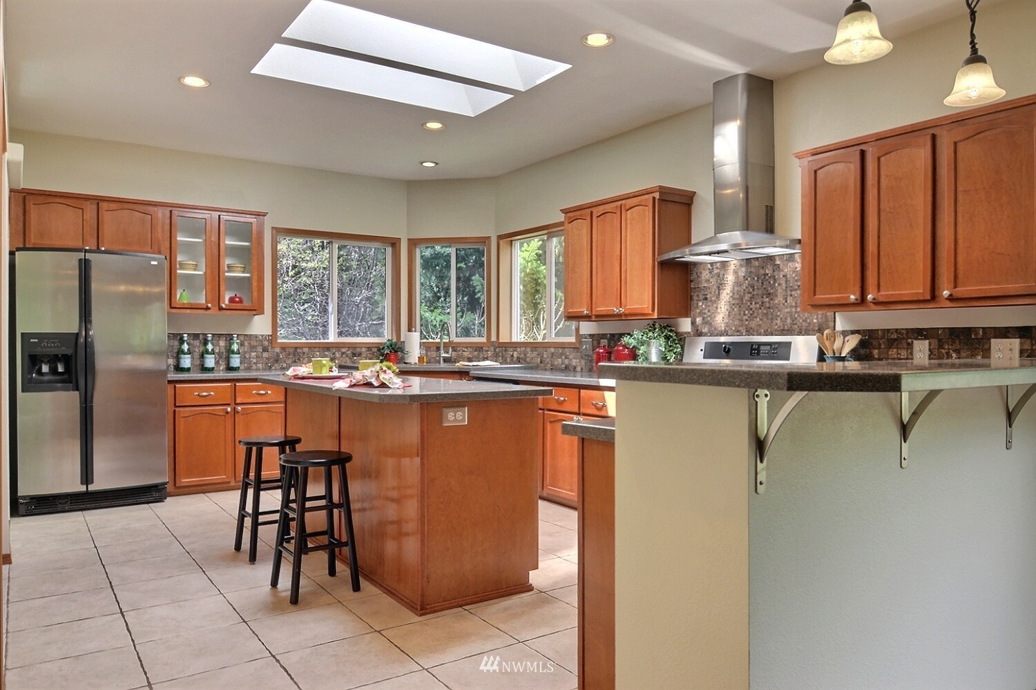 4704 Whiteman Road Southwest Longbranch, WA 98351 - Photo 8 of 40 a kitchen with stainless steel appliances granite countertop a refrigerator and a stove