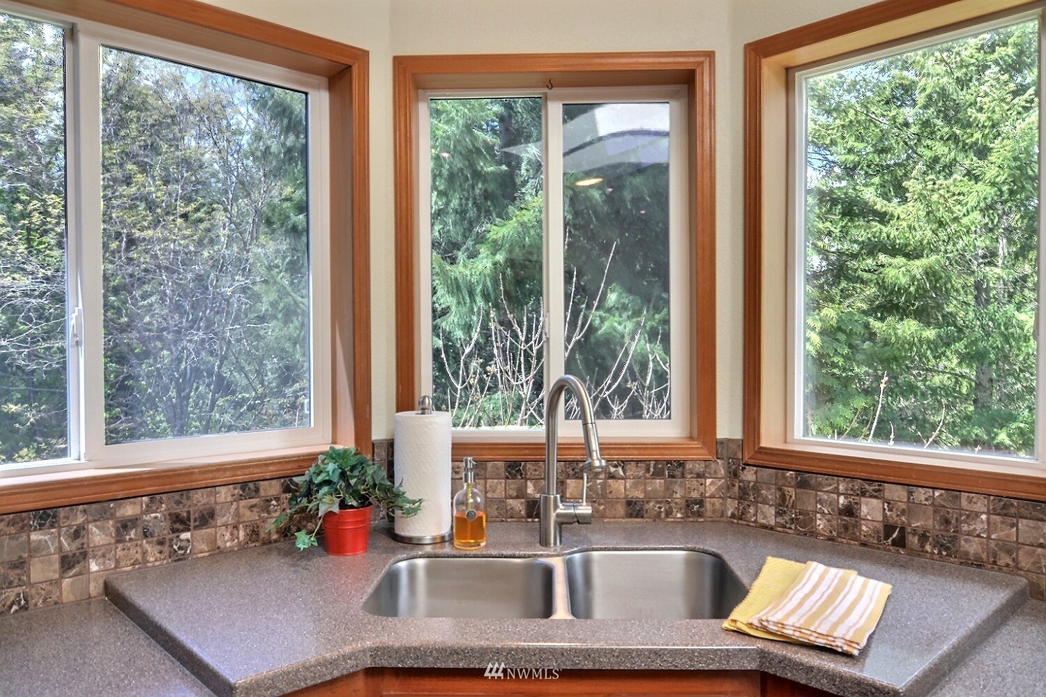 4704 Whiteman Road Southwest Longbranch, WA 98351 - Photo 10 of 40 a bathroom with a granite countertop sink and a large window