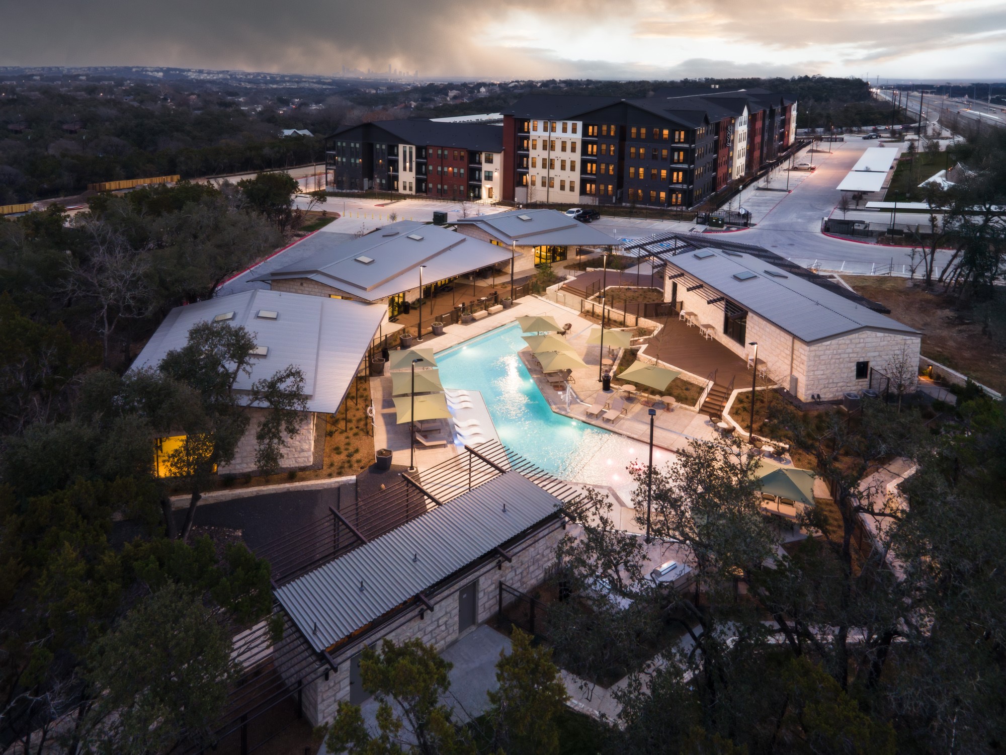 8107 Wilder Road Austin, TX 78736 - Photo 26 of 35 An aerial perspective reveals a modern apartment complex with a sparkling pool area.