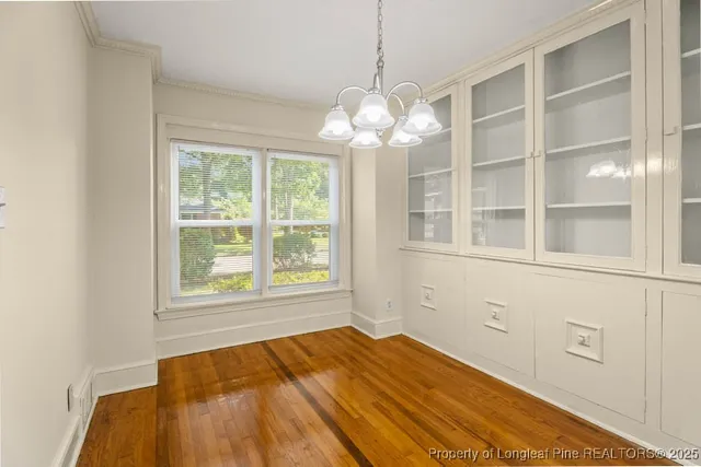 a view of a room with a large window and chandelier