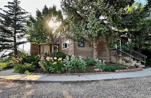 a front view of a house with lots of trees