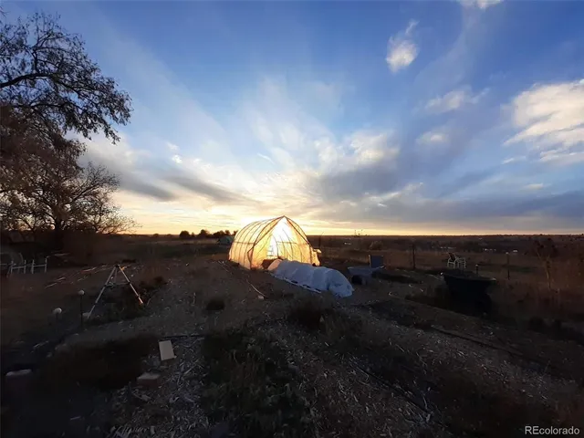 a view of a yard with wooden fence