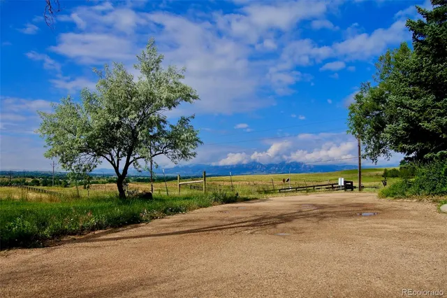 a view of a street with a yard