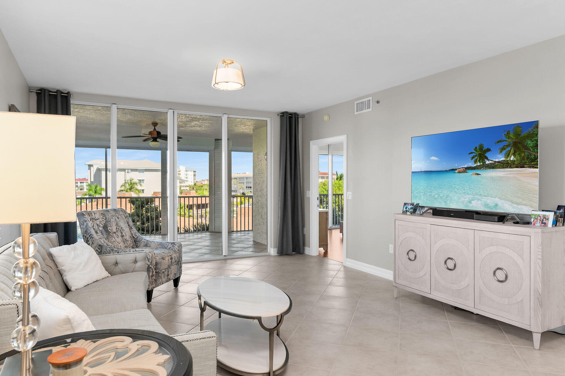 1111 Swallow Avenue, Unit 1401 Marco Island, FL 34145 - Photo 16 of 36 a living room with furniture a flat screen tv and a large window