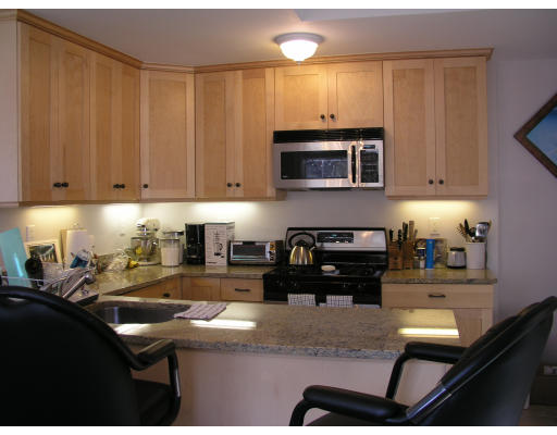 21 Harris Street, Unit 2 Somerville, MA 02140 - Photo 8 of 13 a kitchen with granite countertop a stove sink and cabinets
