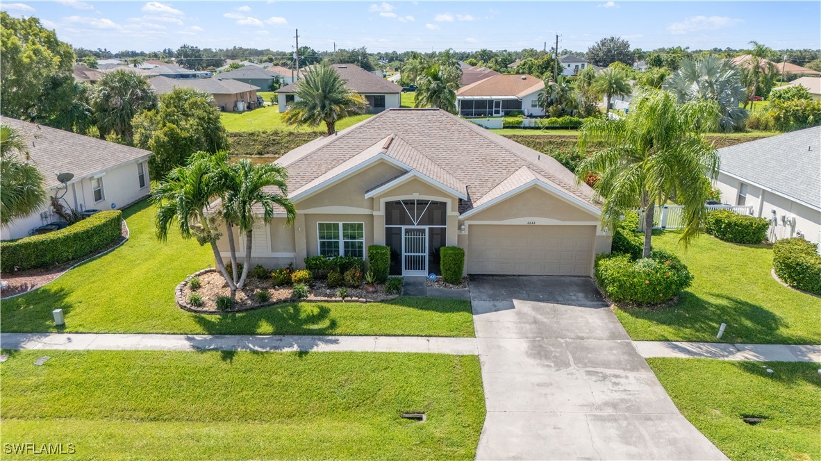 an aerial view of a house with swimming pool garden and patio