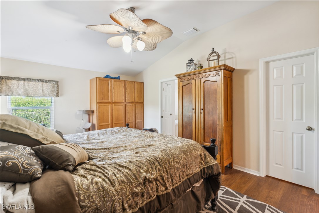 4644 Varsity Circle Lehigh Acres, FL 33971 - Photo 14 of 29 a bedroom with a bed and a chandelier