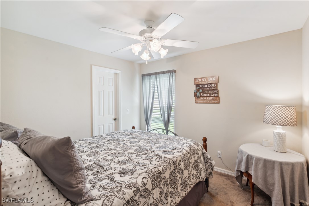 4644 Varsity Circle Lehigh Acres, FL 33971 - Photo 19 of 29 a bedroom with a bed and a table in it