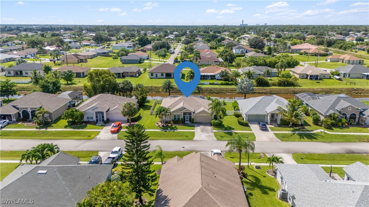 4644 Varsity Circle Lehigh Acres, FL 33971 - Photo 2 of 29 an aerial view of a house with a garden