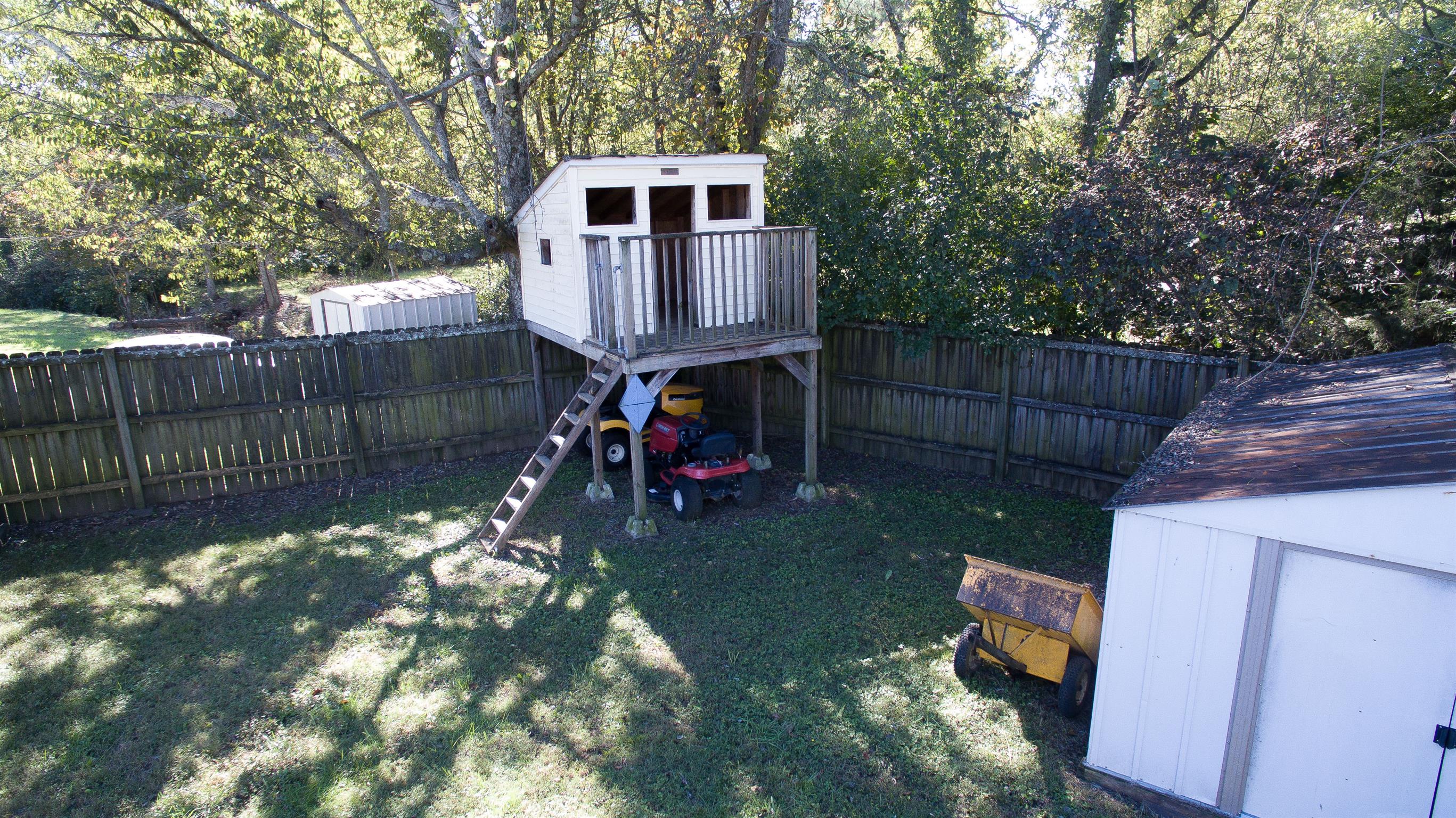 1802 Murfreesboro Road Lebanon, TN 37090 - Photo 14 of 23 a view of a backyard with a small cabin and a chair