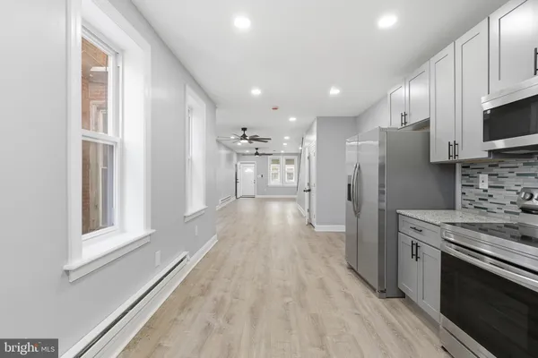 a view of a kitchen with a stove cabinets and a wooden floor