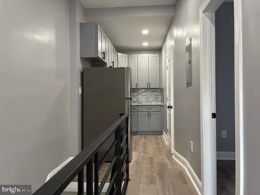 a kitchen with kitchen island white cabinets and refrigerator