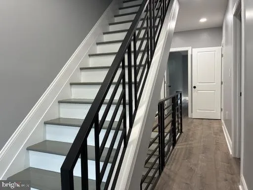 a view of staircase with wooden floor and stairs