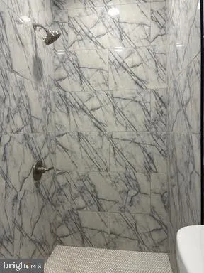 a bathroom with a white toilet and a shower