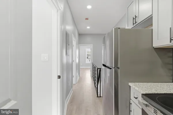 a kitchen with stainless steel appliances a refrigerator and a stove
