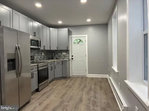 a kitchen with a refrigerator stove and microwave