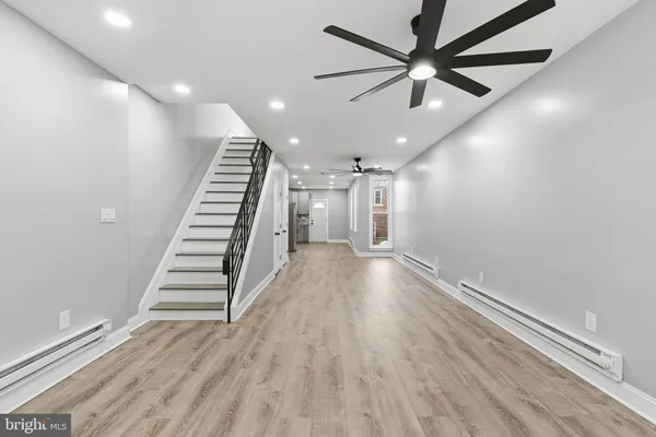 wooden floor in an empty room with a chandelier