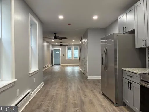 a view of a refrigerator in kitchen and wooden floor