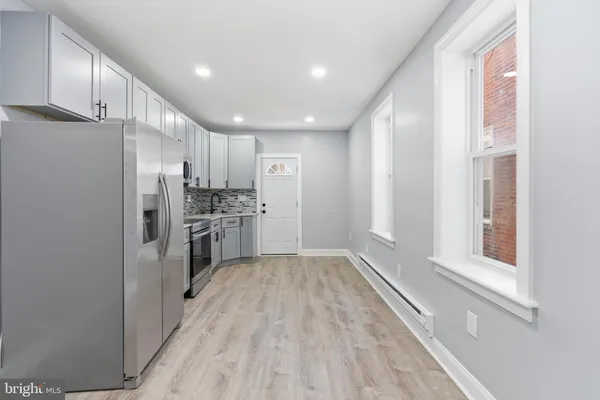 a kitchen with a refrigerator and a sink