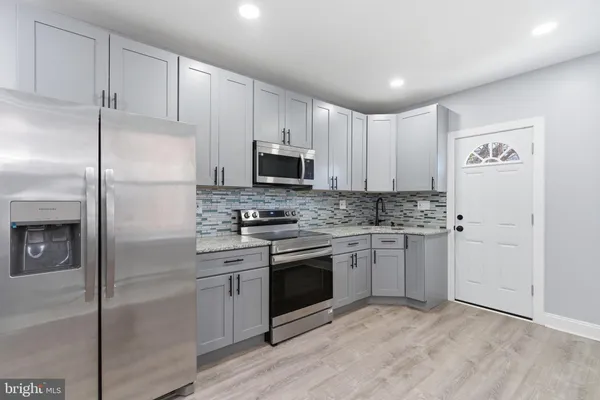 a kitchen with a refrigerator stove and microwave