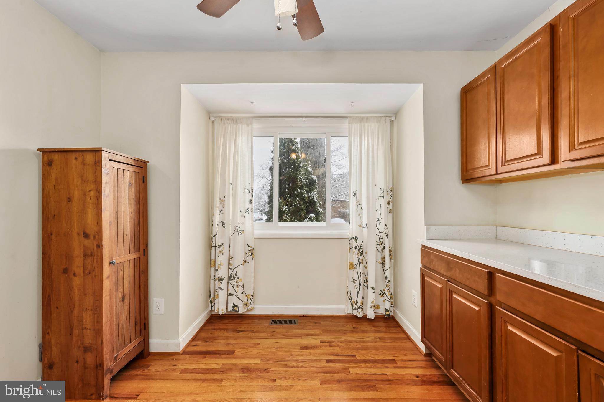 302 Giles Place Sterling, VA 20164 - Photo 3 of 23 a view of a hallway with wooden floor and cabinet
