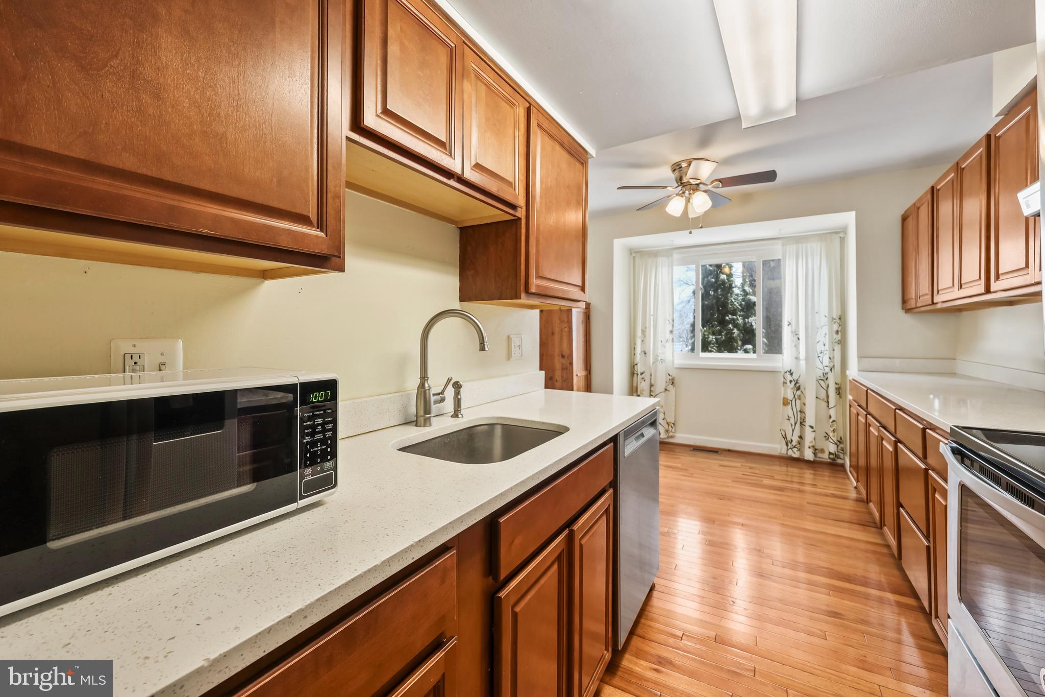 302 Giles Place Sterling, VA 20164 - Photo 4 of 23 a kitchen with stainless steel appliances a sink and cabinets