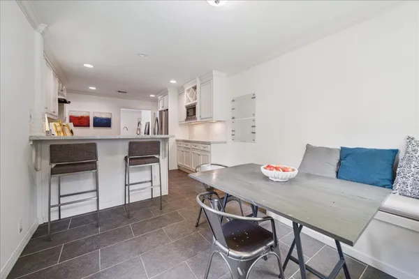 a view of kitchen with cabinets table and chairs