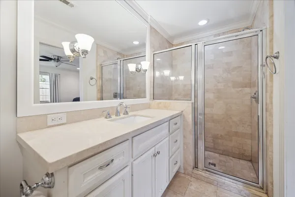 a bathroom with a shower sink vanity and mirror